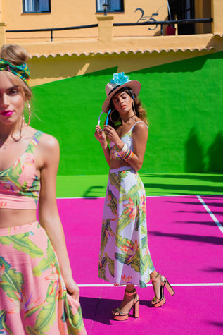 Dancing Leopard models on a pink and green tennis court