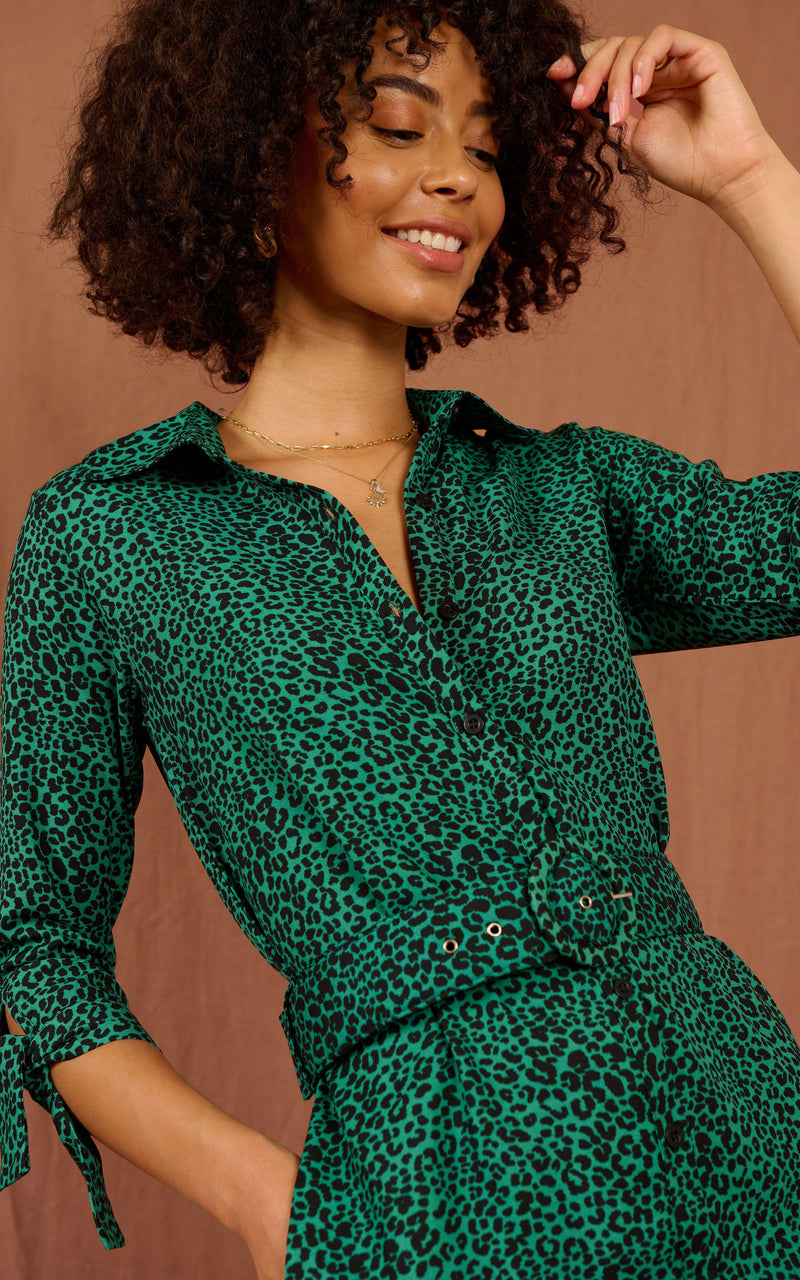 Close up of Dancing Leopard model standing forwards wearing Jonah mini shirt dress in small green leopard
