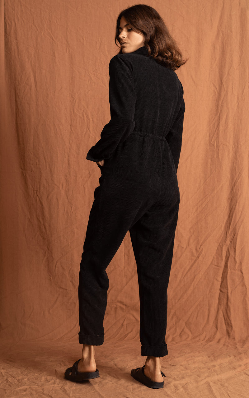 Dancing Leopard model faces backwards wearing Blaze Boilersuit in Black with sandals
