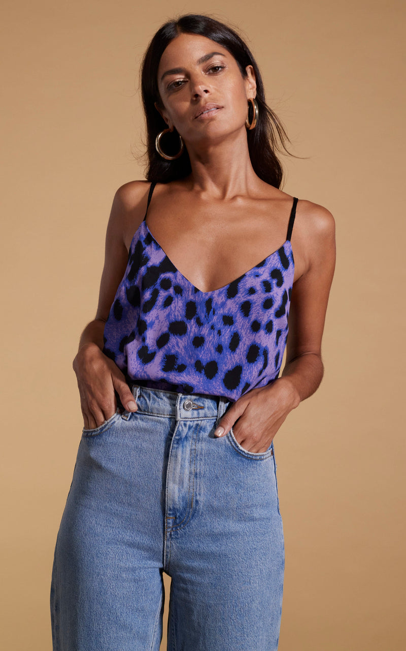 Dancing Leopard model wearing Birdie Cami Top in Lilac Leopard posed with hands in jeans pockets